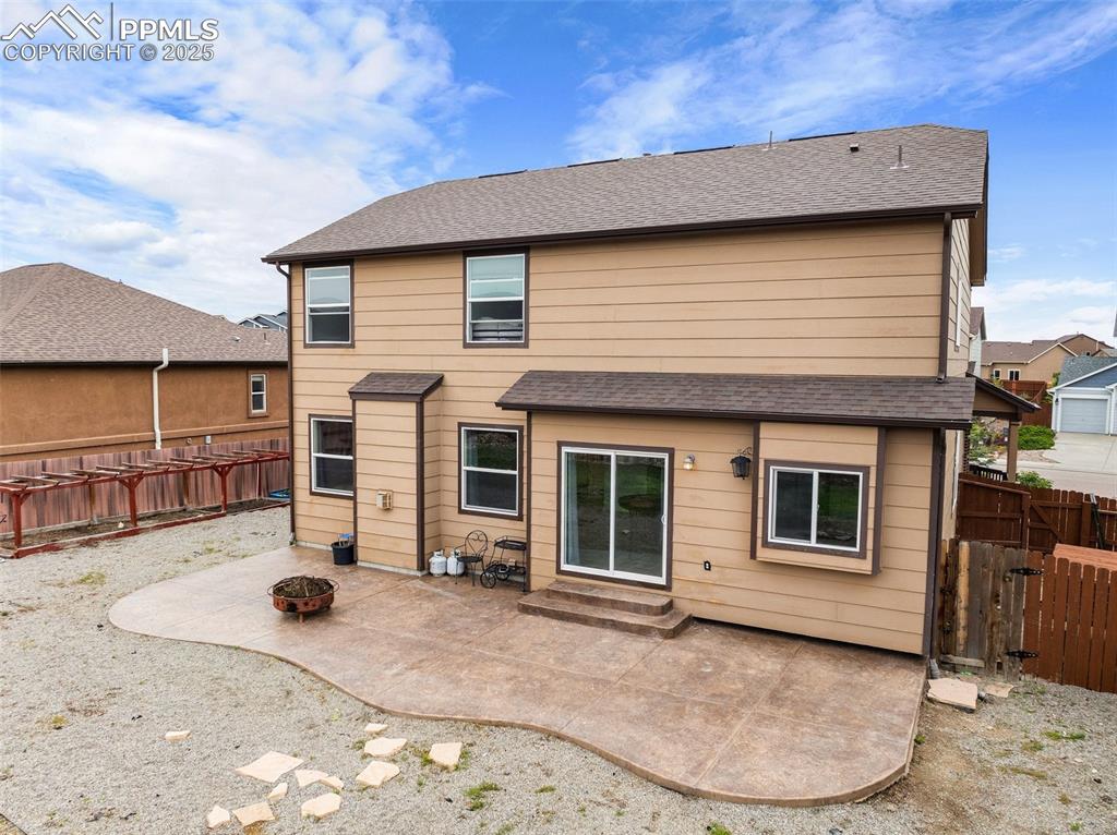 Image 39 of 50: Backyard includes Stamped Concrete Patio, Dedicated Dog Run , Garden Bed Ar