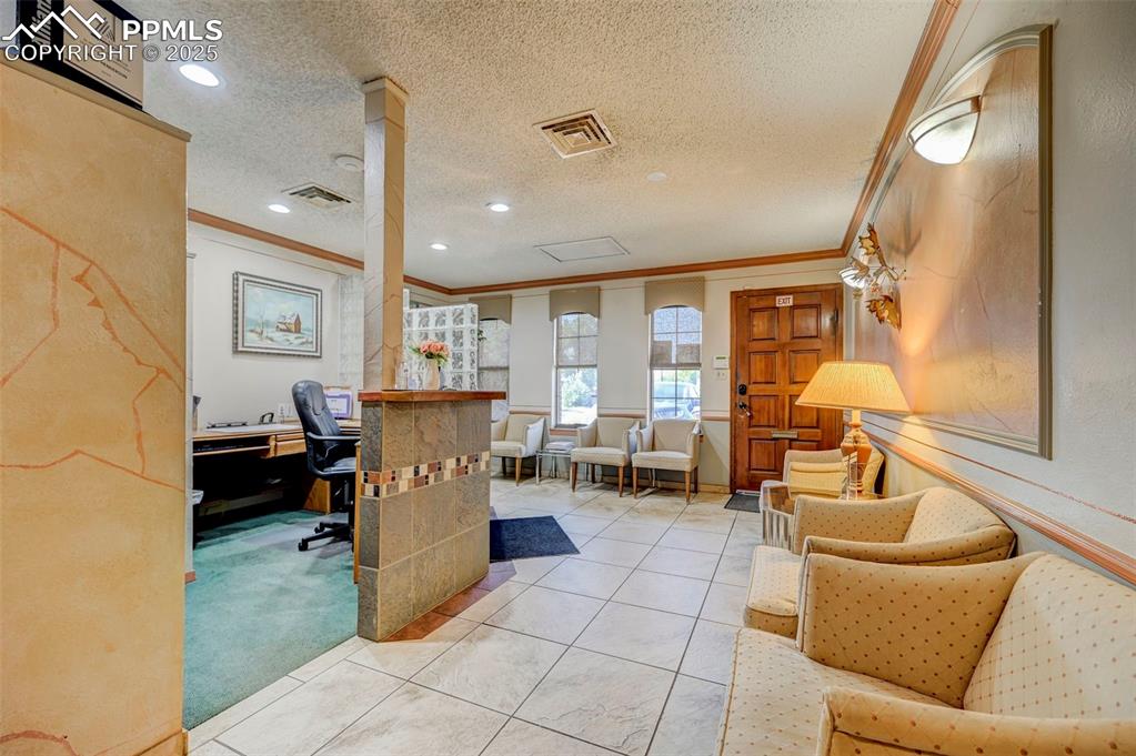 Image 12 of 45: Office featuring ornamental molding, a textured ceiling, recessed lighting,