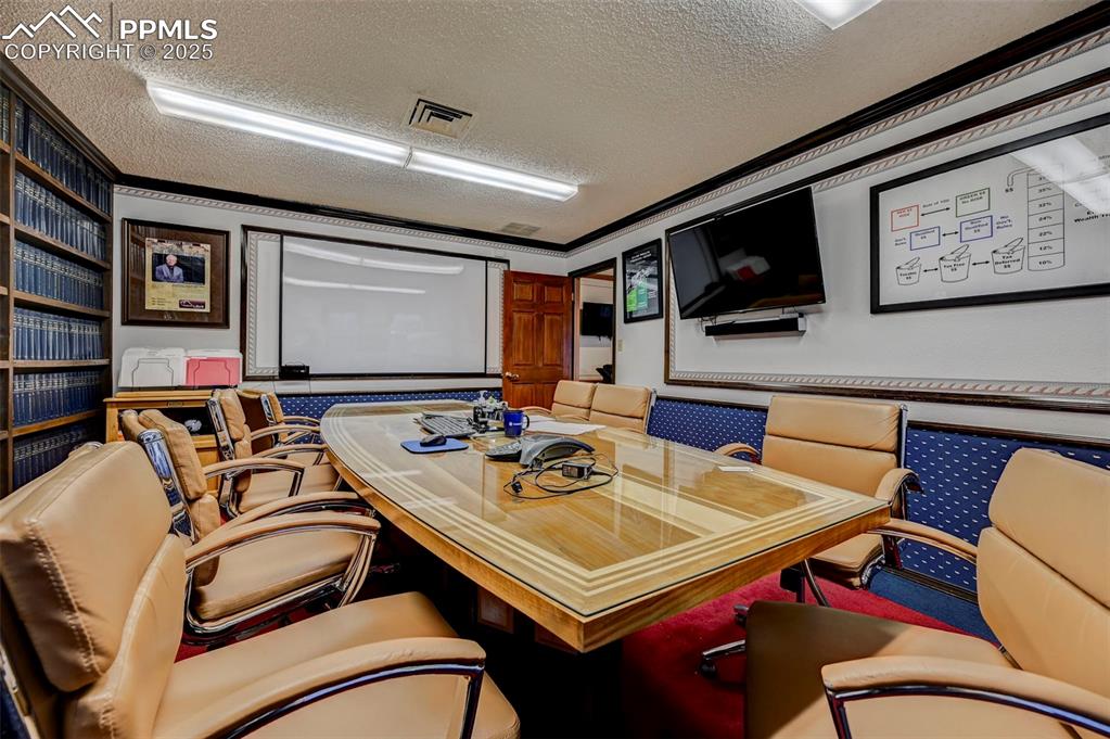 Image 15 of 45: Office area featuring a textured ceiling and ornamental molding