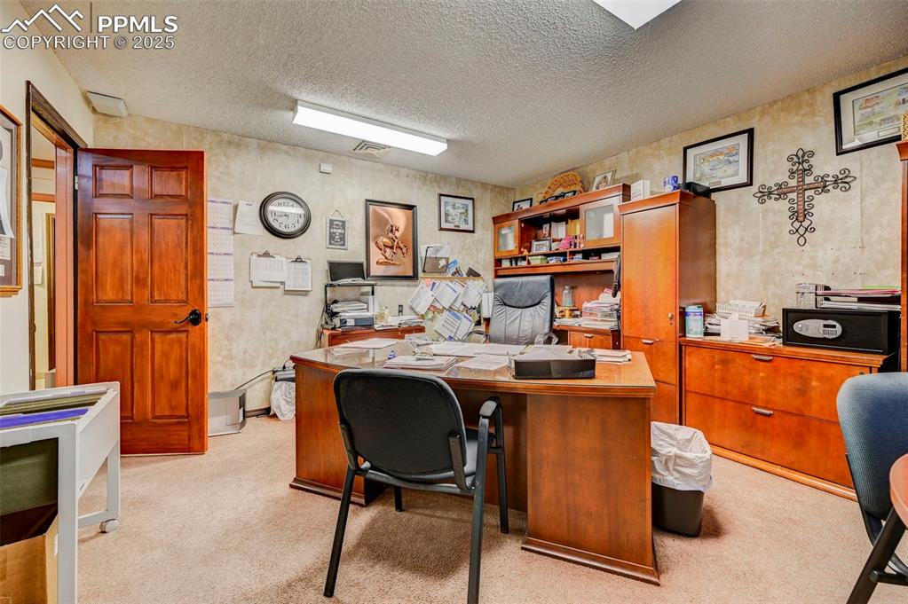 Image 18 of 45: Carpeted office space with a textured ceiling