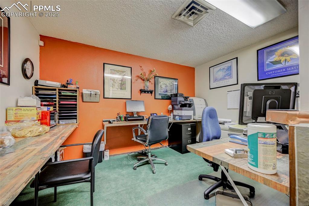 Image 24 of 45: Carpeted office space featuring a textured ceiling