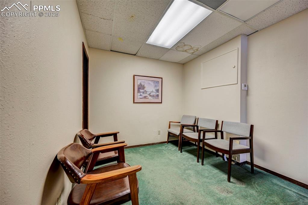 Image 32 of 45: Sitting room featuring a paneled ceiling, carpet, and baseboards