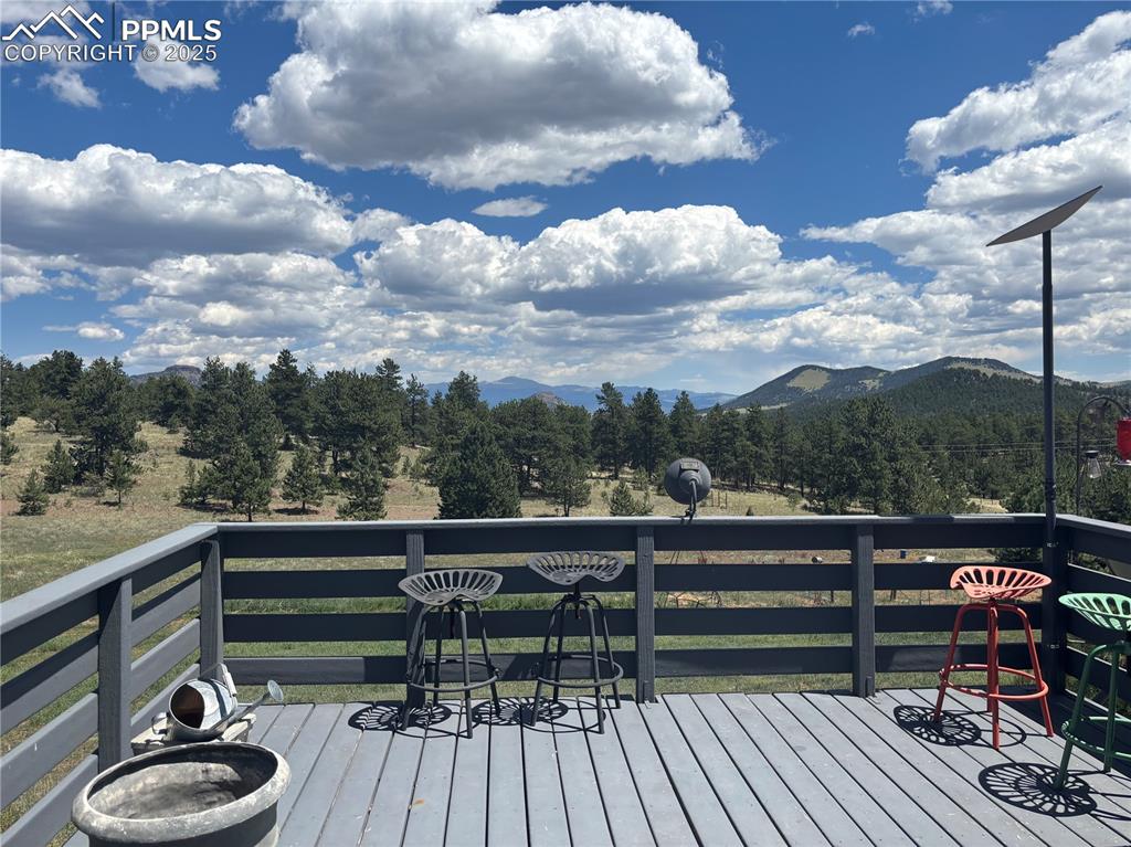 Image 10 of 25: Wooden terrace featuring a mountain view