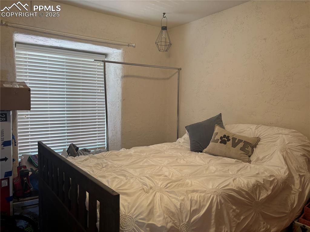 Image 12 of 25: Bedroom featuring a textured wall