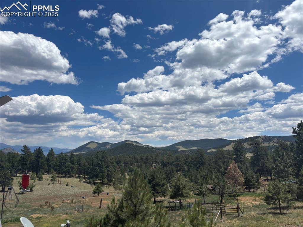 Image 18 of 25: View of mountain backdrop with rural landscape