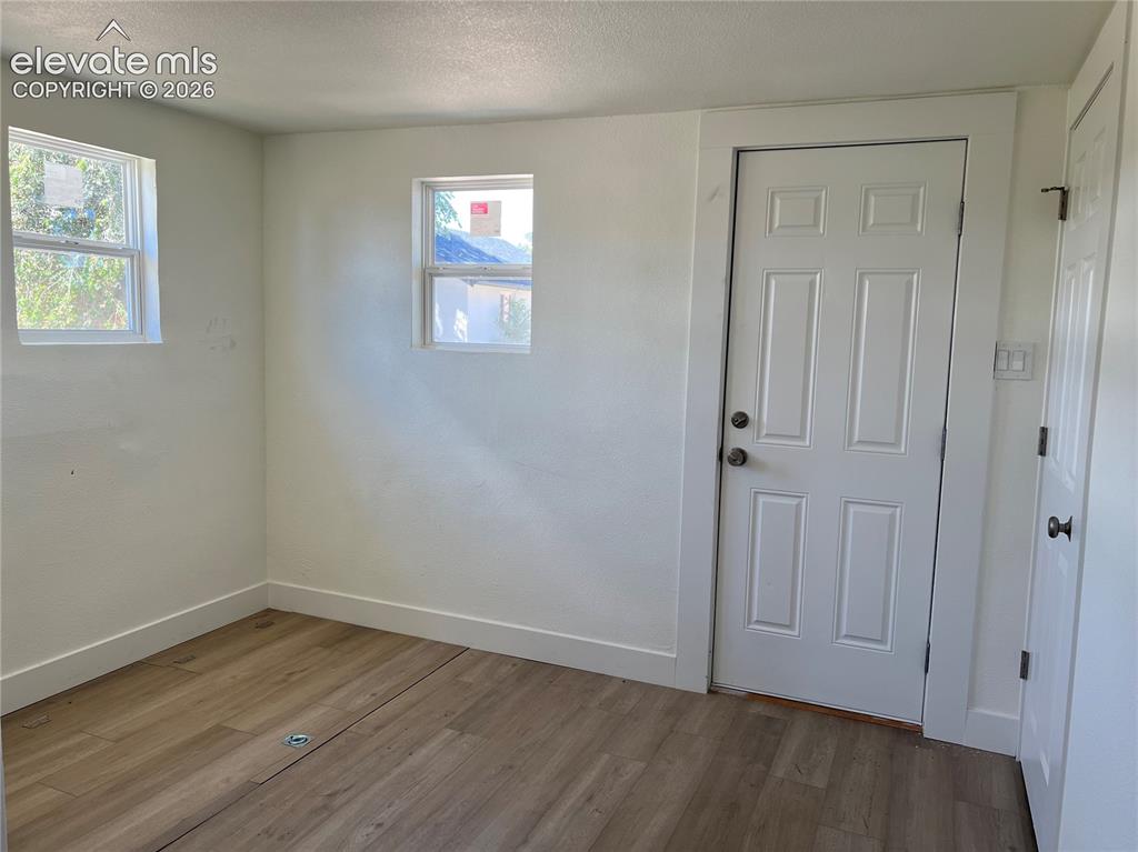 Image 12 of 23: Main House - Other room with laundry and rear entry