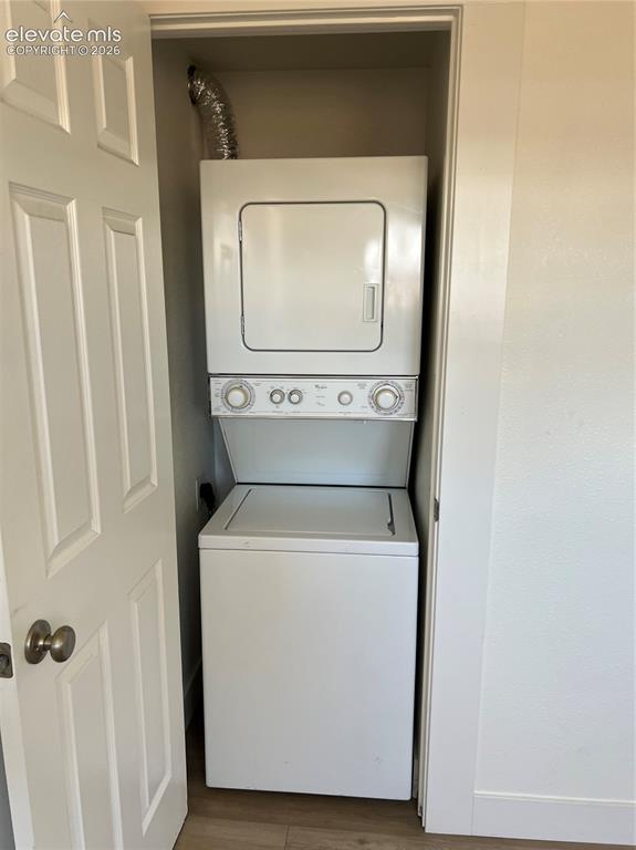 Image 13 of 23: Stackable laundry appliances within a dedicated closet