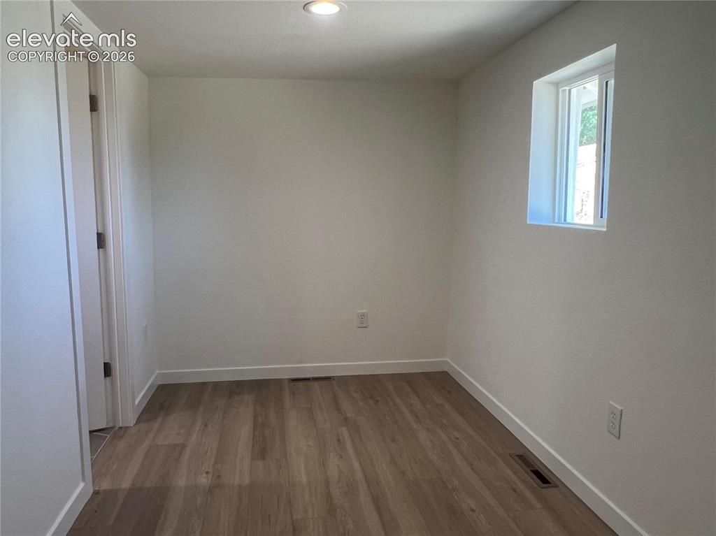Image 19 of 23: Cottage Bedroom with luxury vinyl plank flooring