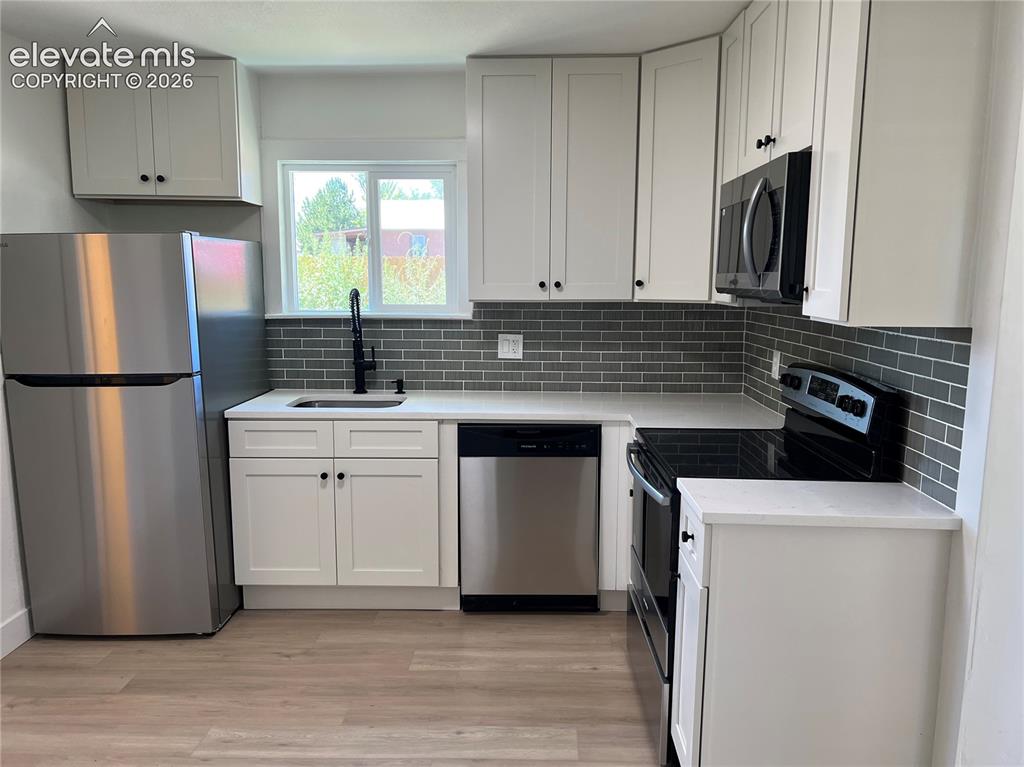 Image 3 of 23: Main House - White cabinetry, stainless steel appliances, Quartz countertop