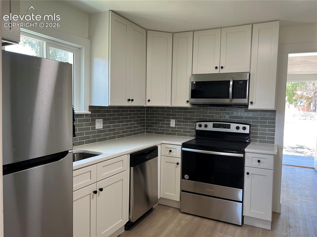 Image 4 of 23: Main House - White cabinetry, stainless steel appliances, Quartz countertop