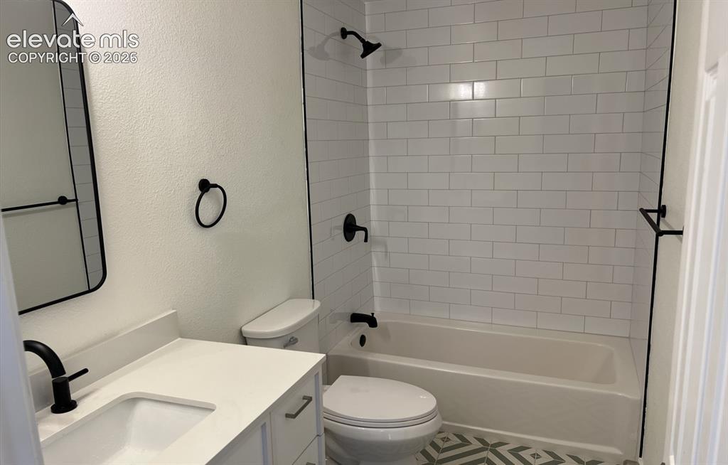 Image 7 of 23: Main House - Bathroom featuring a white subway tile shower surround, integr