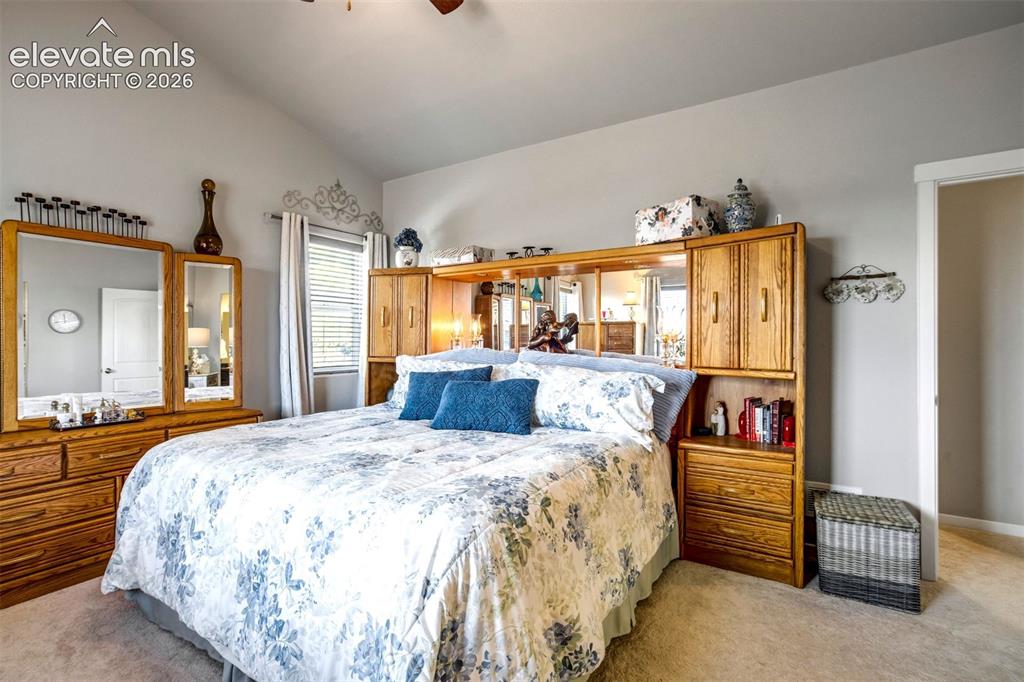 Image 18 of 43: Large primary bedroom with ample light and vaulted ceilings