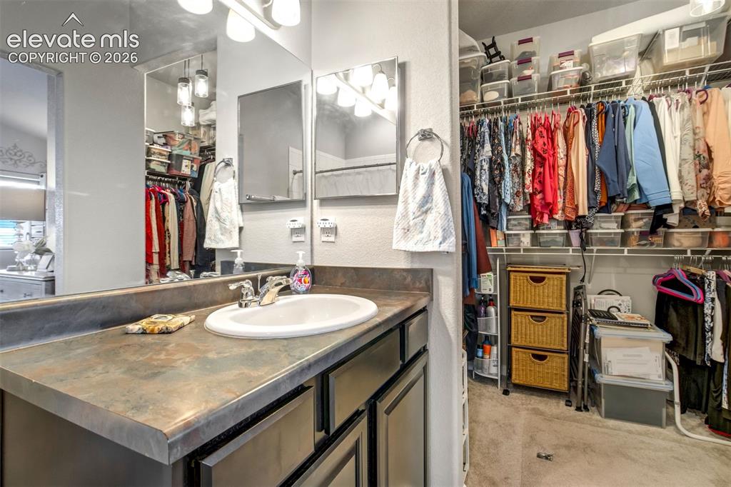 Image 22 of 43: Walk-in closet with crawl space access