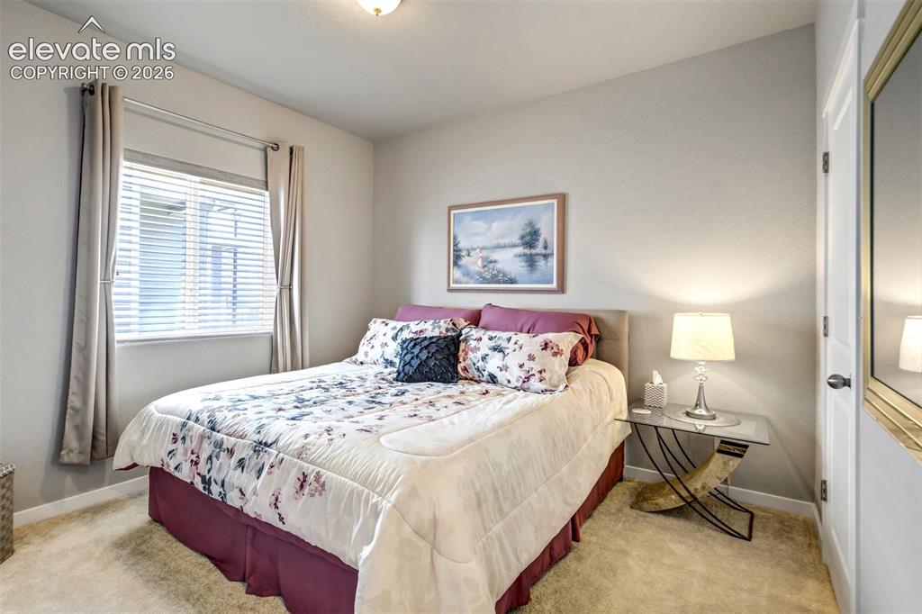 Image 23 of 43: 2nd bedroom shown with a king-sized bed