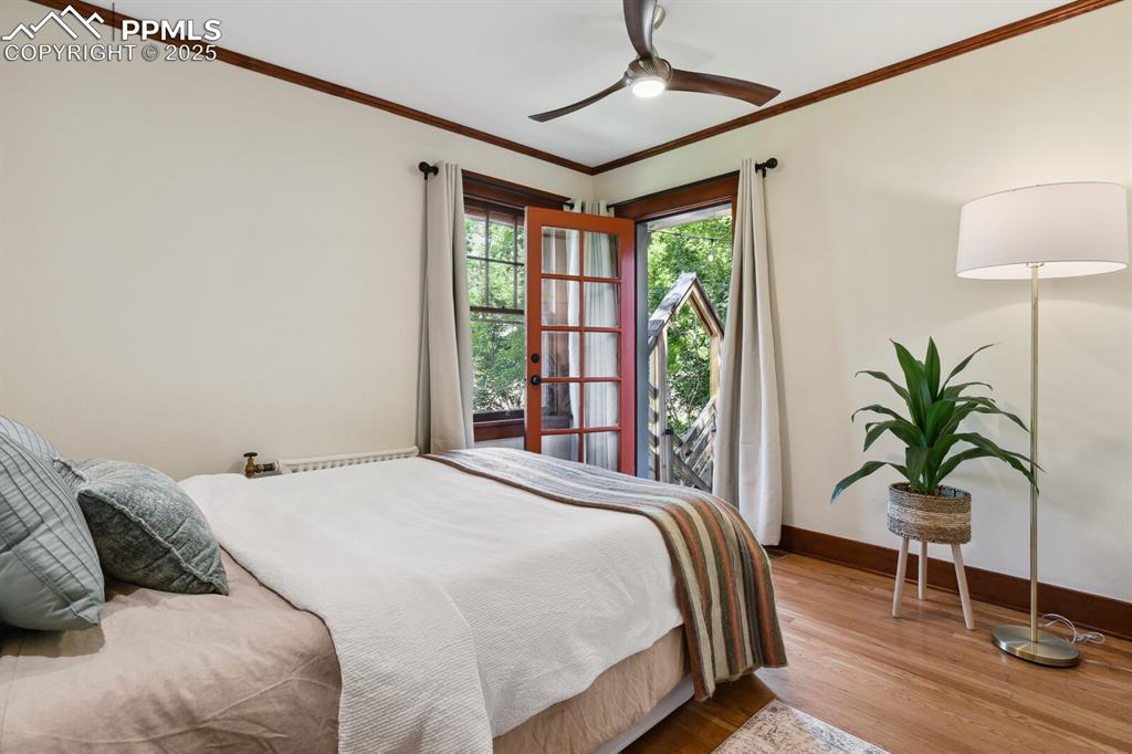 Image 21 of 49: Primary bedroom with adoining bathroom and door leading to the back courtya