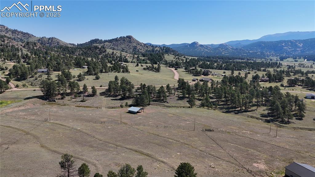 Image 20 of 44: Aerial view of sparsely populated area featuring mountains