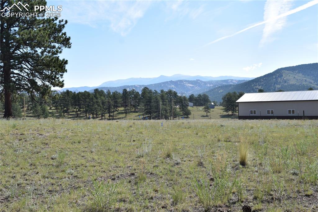 Image 37 of 44: View of mountain backdrop with rural landscape