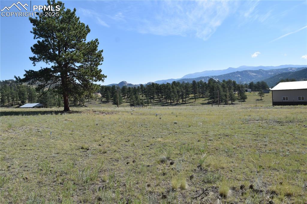 Image 39 of 44: View of mountain backdrop with rural landscape