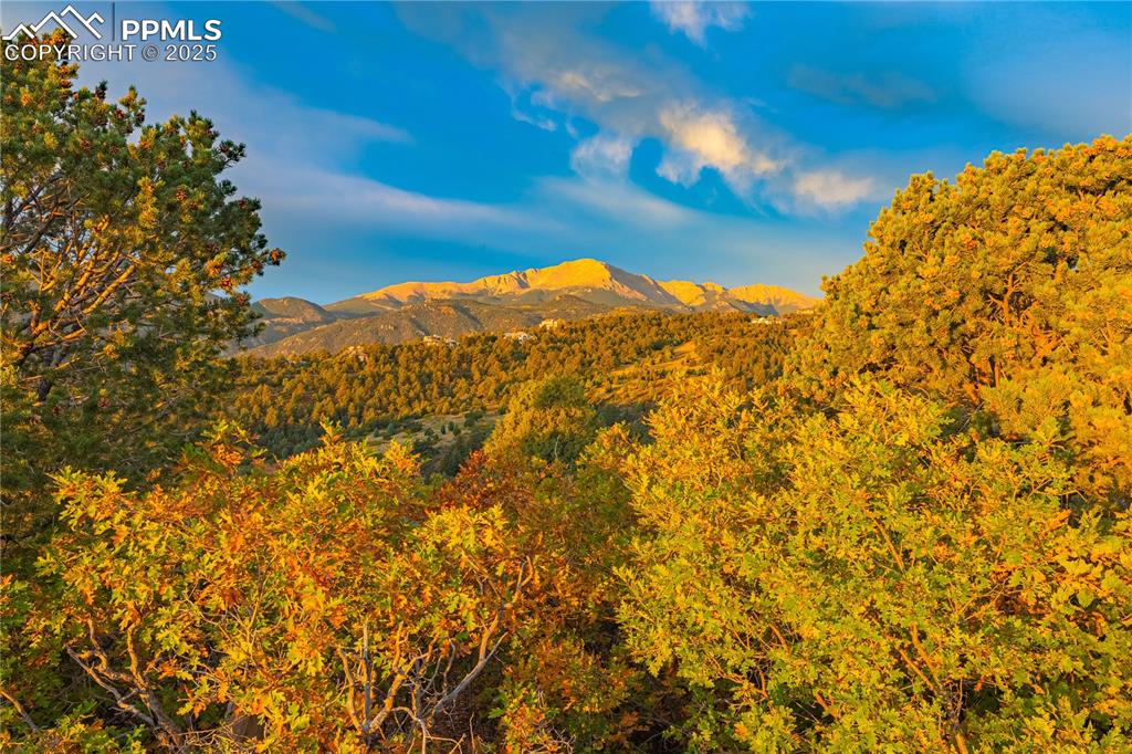 Image 12 of 19: Frame Pikes Peak views with a custom home build