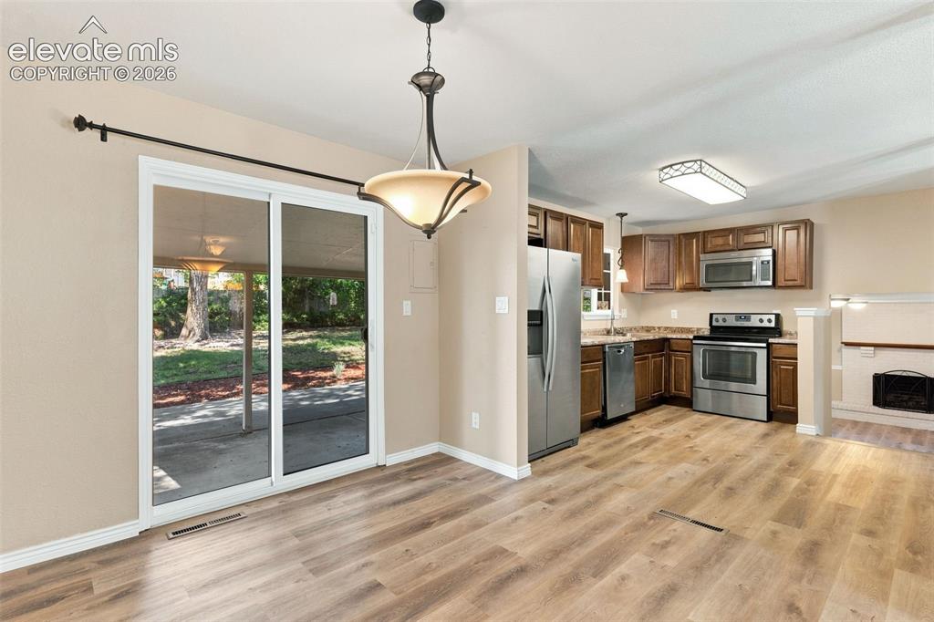 Image 12 of 39: The dining area provides access to the covered patio in the private backyar