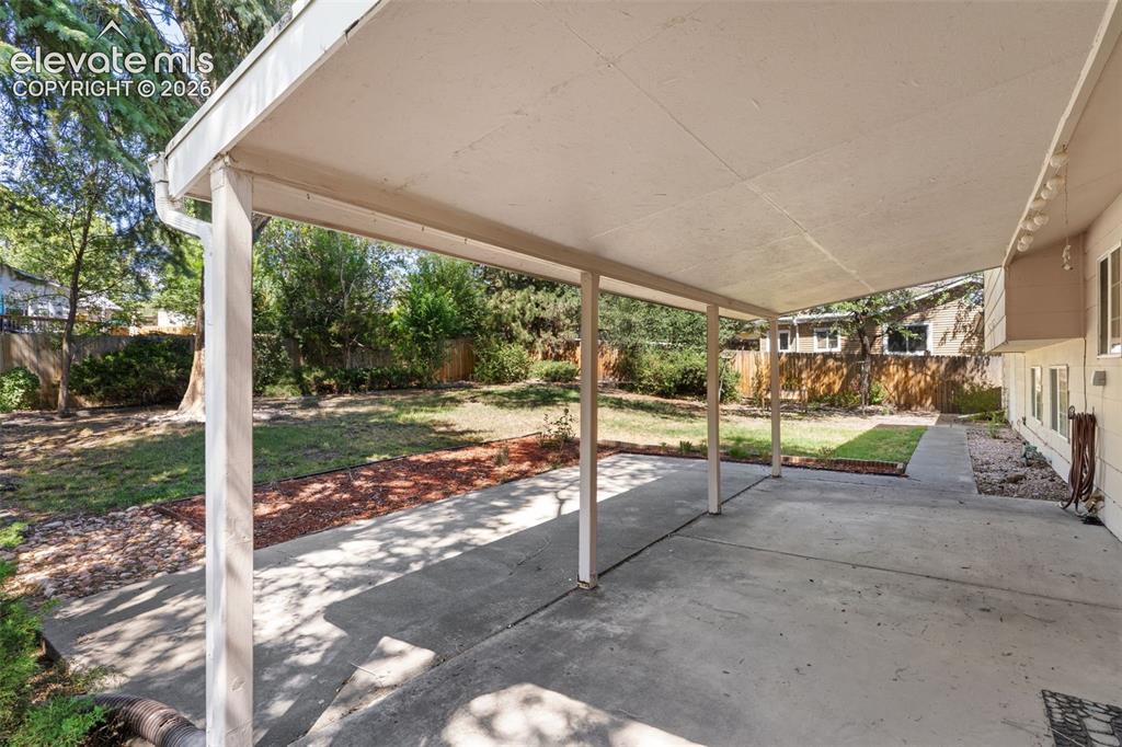 Image 14 of 39: Picture yourself on this awesome covered patio relaxing with a drink to unw