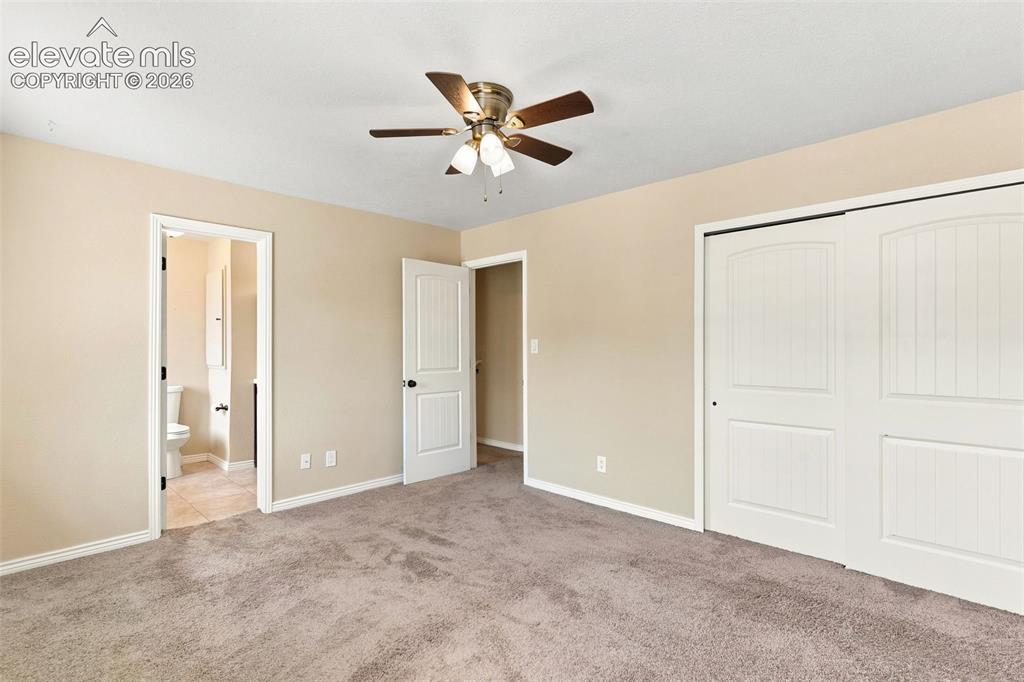 Image 19 of 39: The upper level primary bedroom adjoins a tiled full bath.