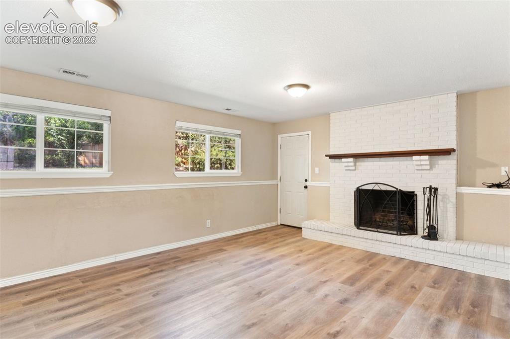 Image 27 of 39: This large family room on the lower garden level is bathed in natural light