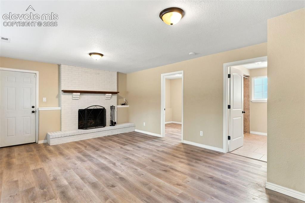 Image 29 of 39: The lower level includes a 4th bedroom and tiled 3/4 bath accessible from t
