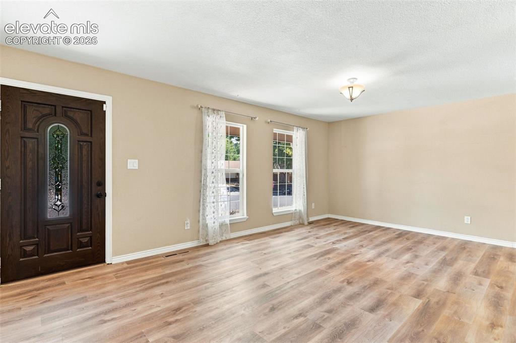 Image 3 of 39: The spacious living room is open and bright.