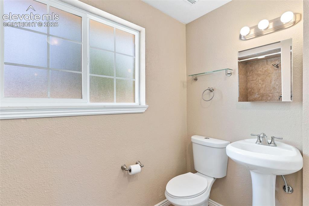 Image 32 of 39: The lower level includes this 3/4 bath, so convenient to the family room an