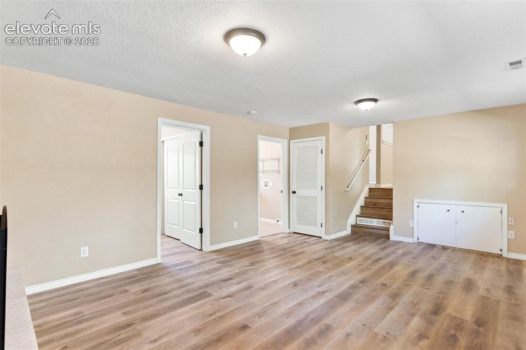 Image 34 of 39: View from family room showing entrances to 4th bedroom and 3/4 bath/laundry