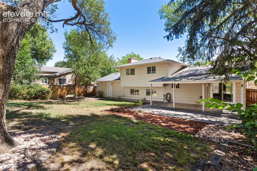 Image 38 of 39: The backyard is shaded by mature trees around the perimeter. So much cooler