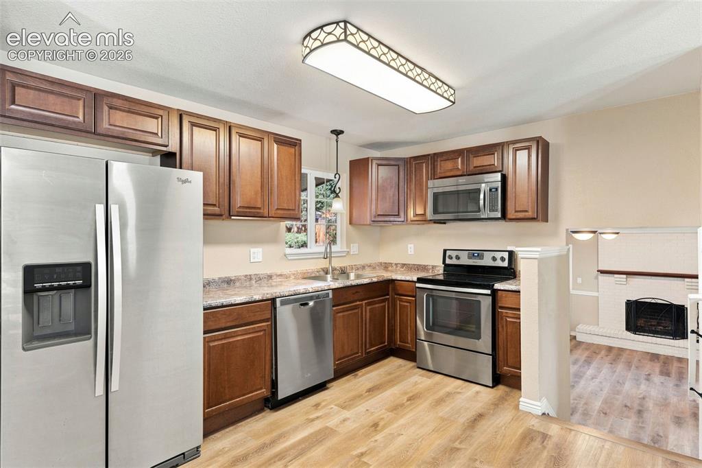 Image 6 of 39: The charming kitchen is appointed with ample cupboards and counterspace. Al