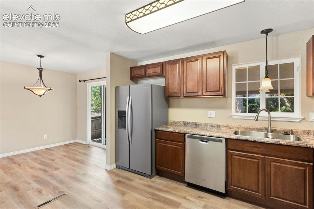Image 8 of 39: The kitchen flows into the dining area.