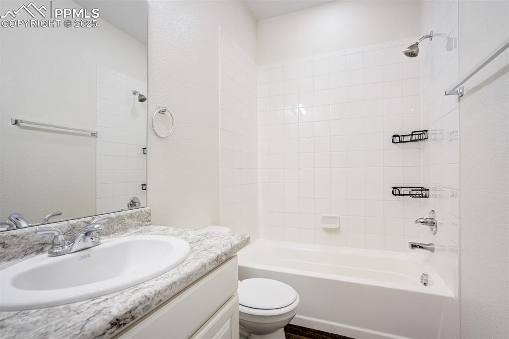 Image 15 of 44: Full bathroom with vanity and shower / washtub combination