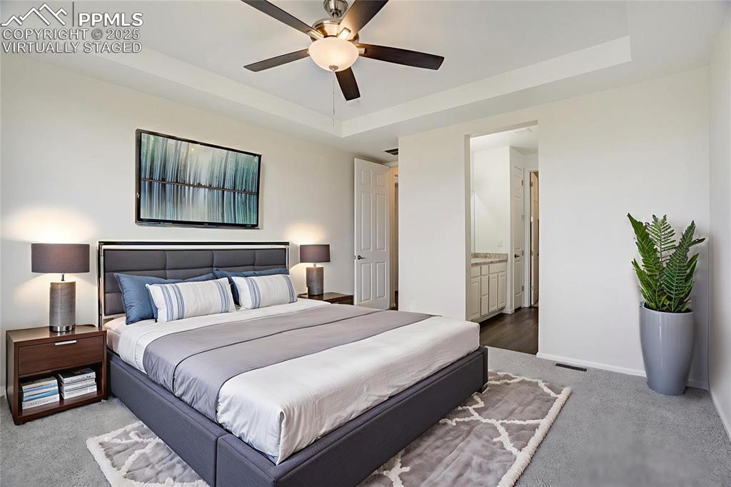 Image 18 of 44: Virtually staged master suite on main level
