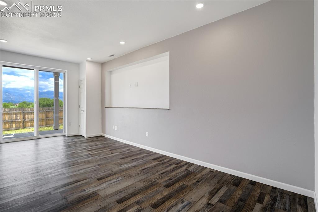 Image 27 of 44: Unfurnished room with dark wood-style flooring and recessed lighting