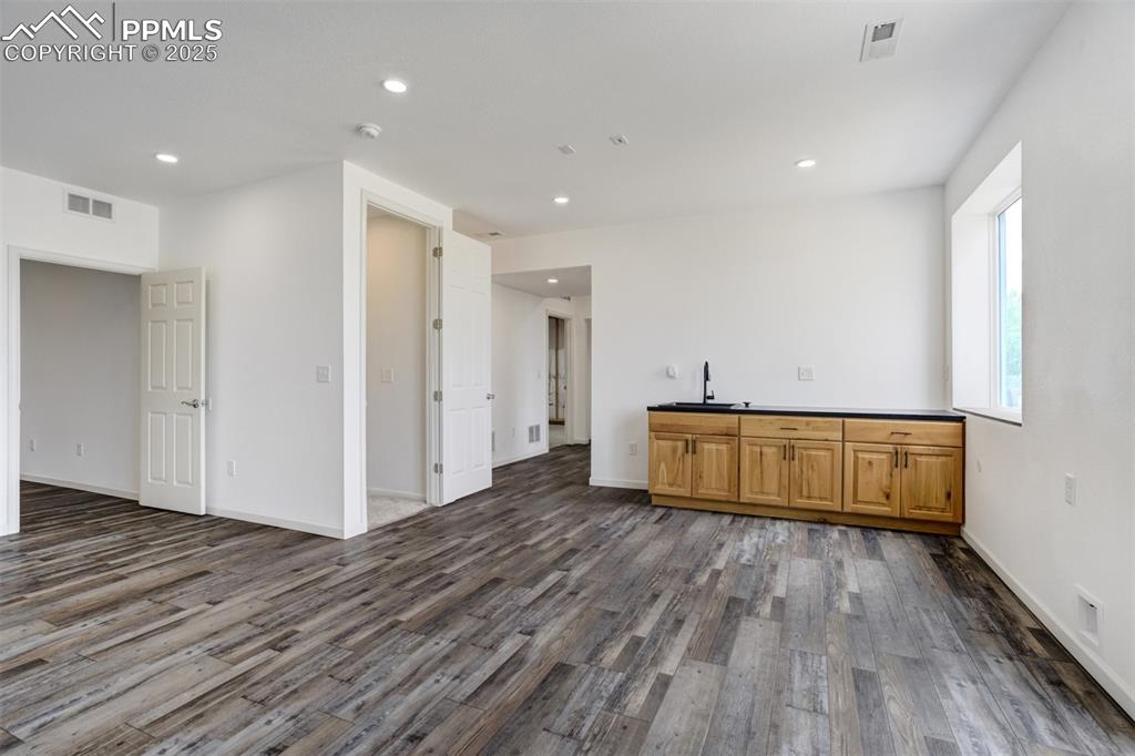 Image 29 of 44: Basement wet bar with garbage disposal