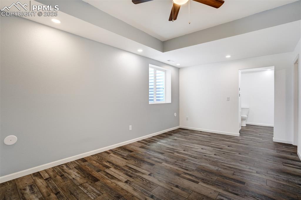 Image 31 of 44: Basement Master suite with ceiling fan, dark wood-style floors, and recesse