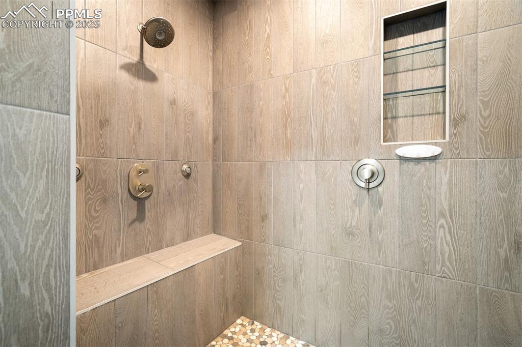 Image 37 of 44: Bathroom with tiled shower