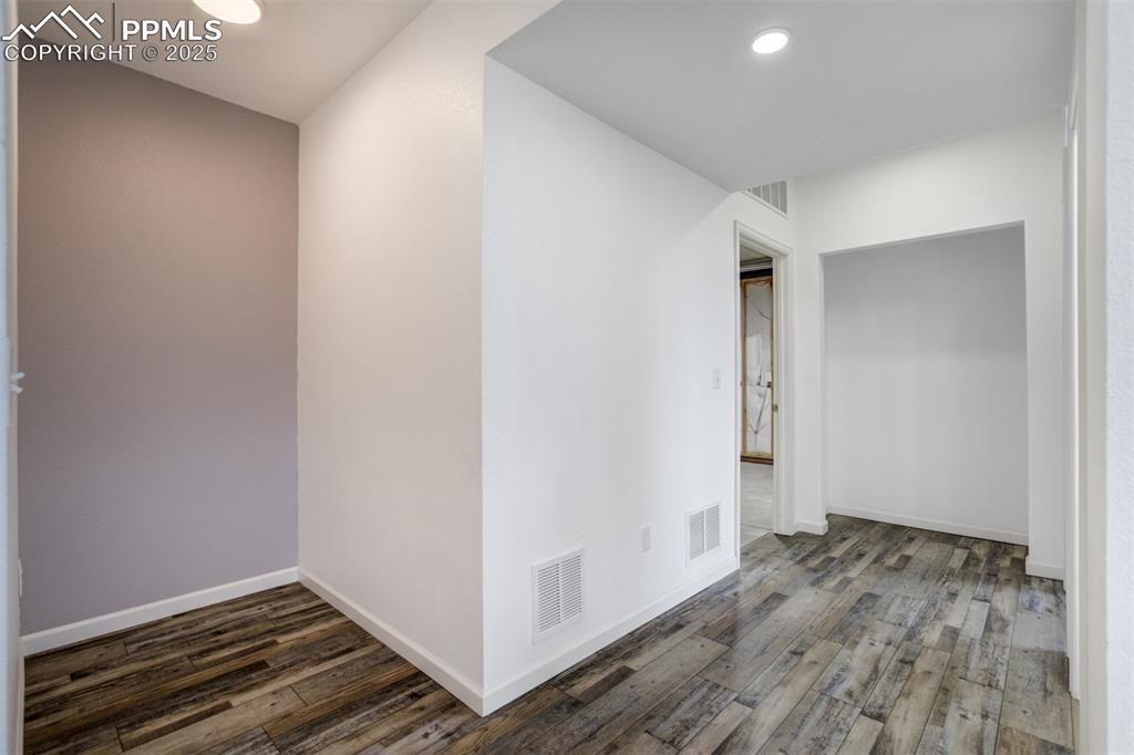 Image 42 of 44: Unfurnished room with wood finished floors and recessed lighting
