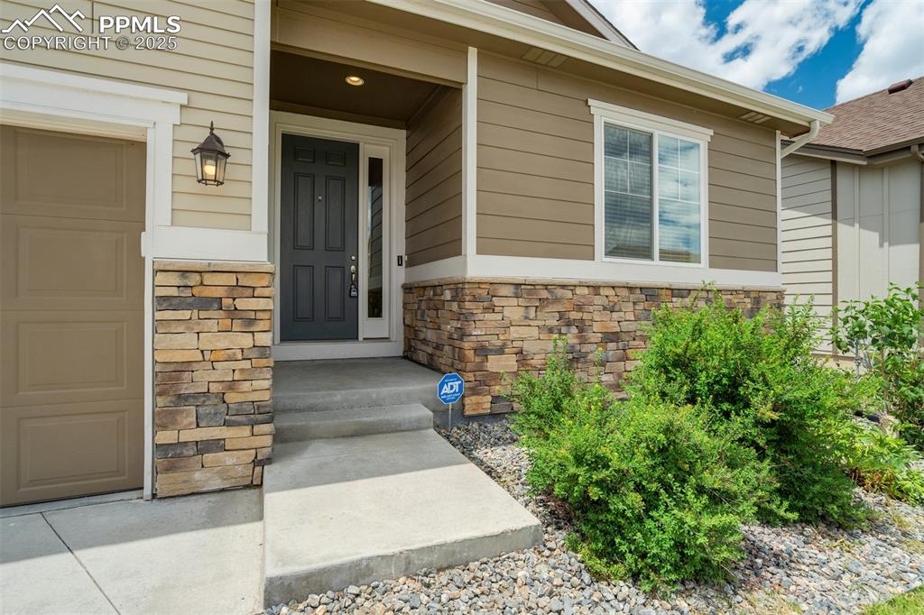 Image 5 of 44: View of exterior entry featuring stone siding