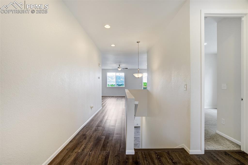 Image 6 of 44: Corridor featuring dark wood-style floors and recessed lighting