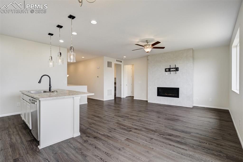 Image 8 of 44: Kitchen with ceiling fan, light countertops,