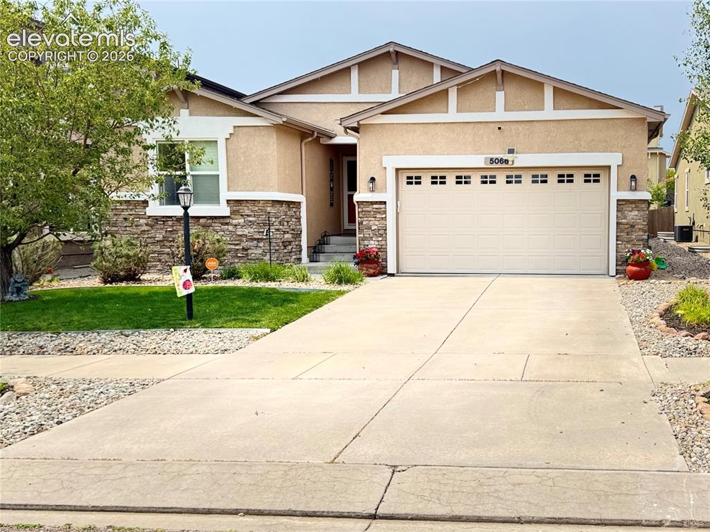 Caption: Stucco exterior with stone veneer accents