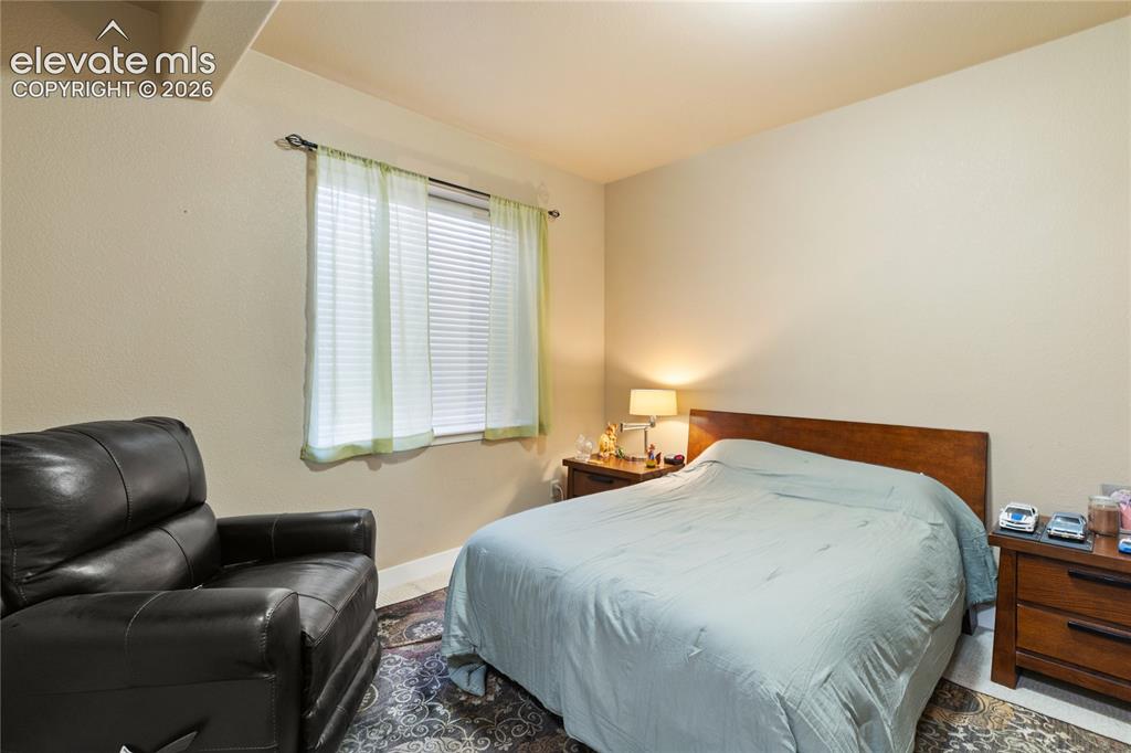 Image 12 of 29: Wood-finish headboard, built-in window with blinds, recessed lighting, and 