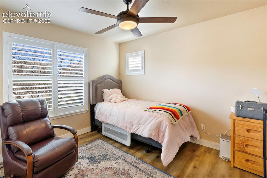 Image 14 of 29: Wood-finish flooring, ceiling fan with integrated lighting, window with pla