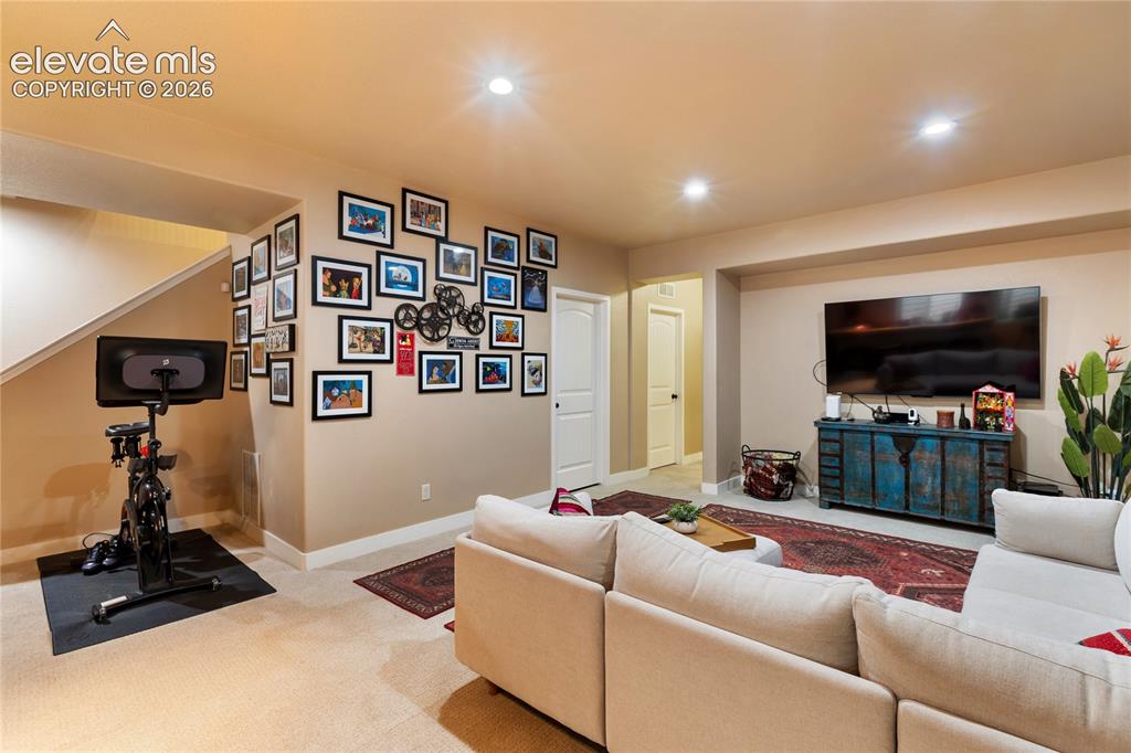 Image 17 of 29: Recessed lighting illuminating a spacious carpeted area