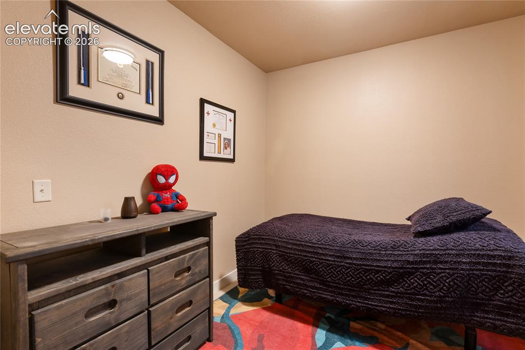Image 23 of 29: Light-colored wall finishes, recessed ceiling lighting, and wood-finish dre
