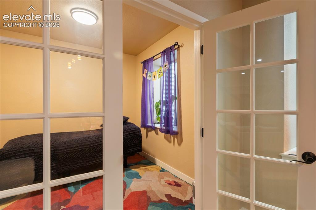 Image 25 of 29: Interior space featuring a window, built-in shelving, and a flush-mount cei